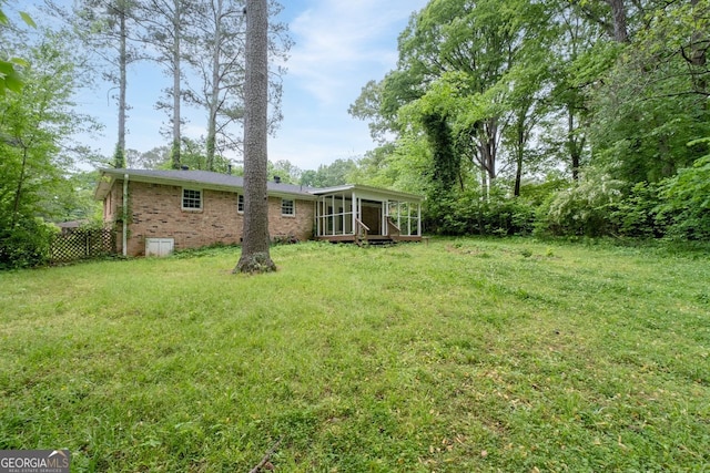 view of yard with a sunroom