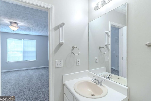8051 Trinity Park Dr, Riverdale, GA 30296 - bathroom featuring vanity, a textured ceiling, and baseboards