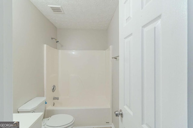 8051 Trinity Park Dr, Riverdale, GA 30296 - full bath with toilet, washtub / shower combination, a textured ceiling, visible vents, and vanity