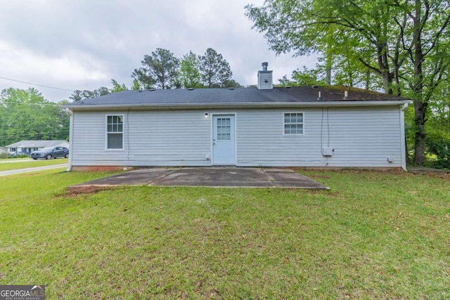 8051 Trinity Park Dr, Riverdale, GA 30296 - back of property featuring a patio area, a chimney, and a lawn