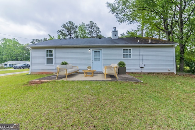 8051 Trinity Park Dr, Riverdale, GA 30296 - back of house featuring a yard, a chimney, and a patio