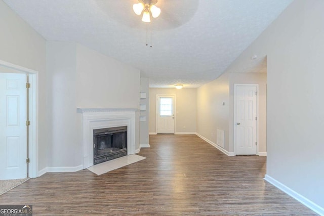 8051 Trinity Park Dr, Riverdale, GA 30296 - unfurnished living room with a fireplace with flush hearth, baseboards, a ceiling fan, and wood finished floors