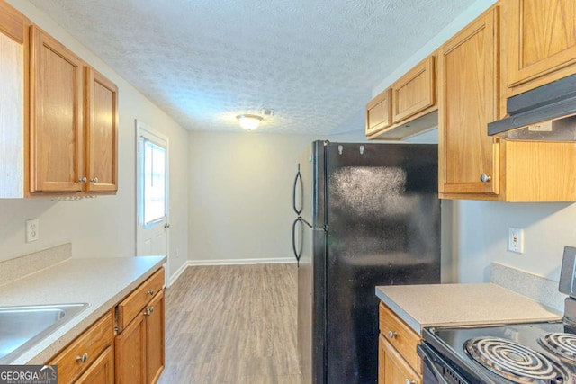 8051 Trinity Park Dr, Riverdale, GA 30296 - kitchen featuring freestanding refrigerator, a textured ceiling, light wood-style flooring, electric range, and baseboards