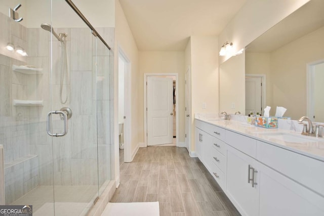 full bath with a shower stall and a sink