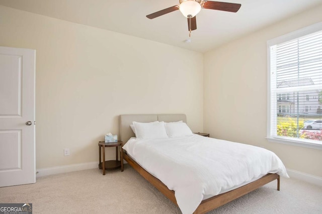 bedroom featuring baseboards, ceiling fan, and carpet flooring