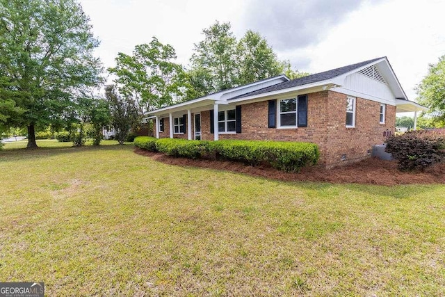 exterior space with a front yard, crawl space, and brick siding