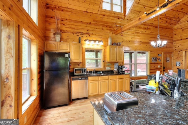 455 Old Cherokee Rd, Cleveland, GA 30528 - kitchen with lofted ceiling, a sink, light wood-style floors, stainless steel appliances, and wooden walls