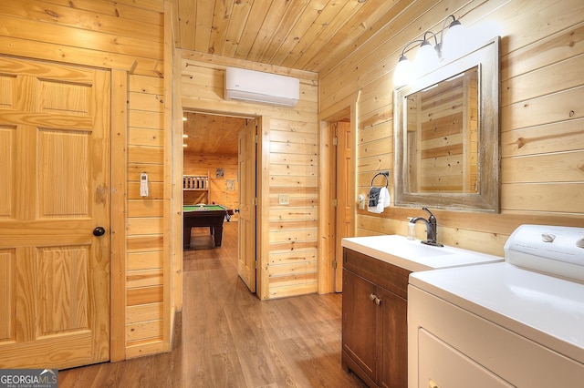 455 Old Cherokee Rd, Cleveland, GA 30528 - laundry area with a sink, cabinet space, a wall unit AC, wooden walls, and washer / clothes dryer