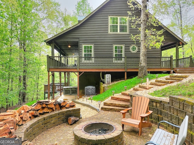 455 Old Cherokee Rd, Cleveland, GA 30528 - back of house featuring a fire pit, a deck, log veneer siding, stairway, and central AC unit
