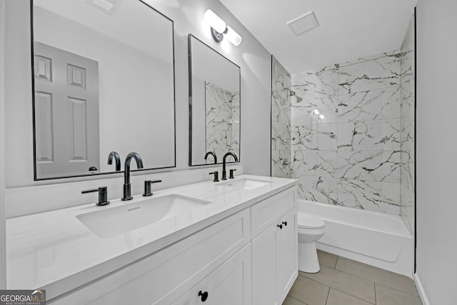 full bathroom with double vanity, a sink, tile patterned floors, and toilet