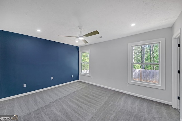 carpeted spare room featuring visible vents, baseboards, ceiling fan, recessed lighting, and a textured ceiling