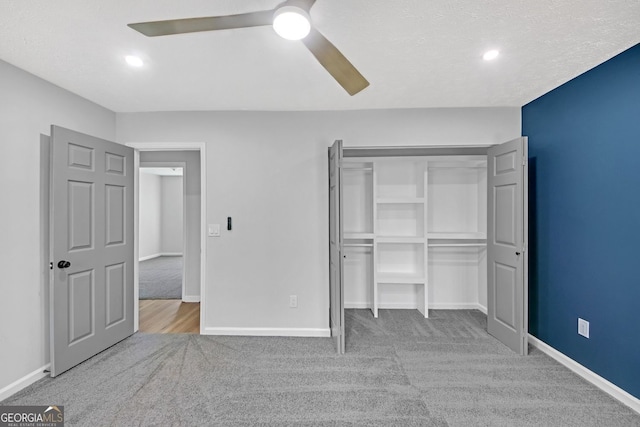 unfurnished bedroom featuring baseboards, ceiling fan, and carpet