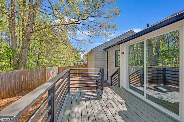 wooden terrace featuring a fenced backyard