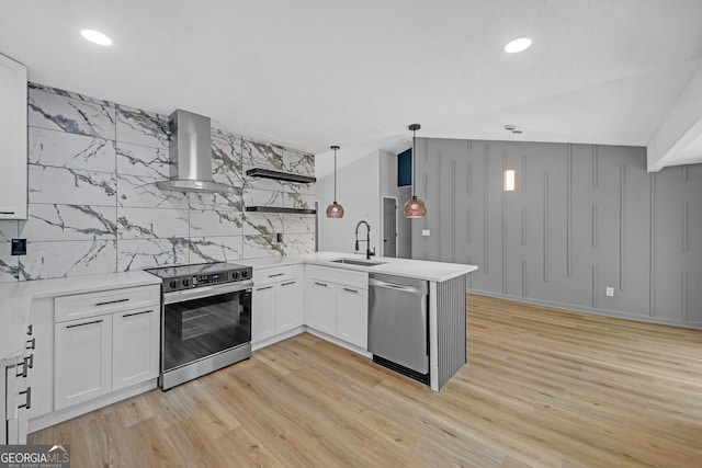 kitchen with a sink, range with electric cooktop, wall chimney exhaust hood, a peninsula, and stainless steel dishwasher