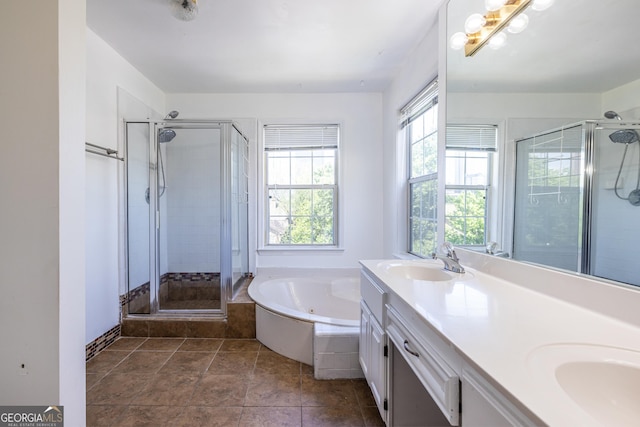 full bathroom with a sink, a garden tub, a stall shower, and double vanity