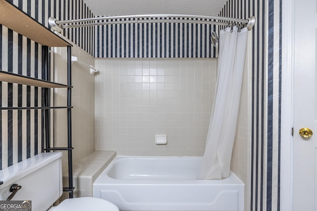 bathroom featuring toilet, wallpapered walls, and shower / bath combination with curtain
