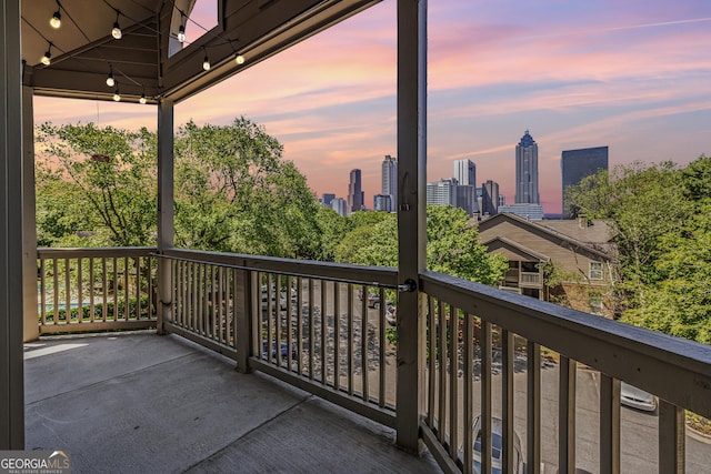 balcony at dusk with a view of city