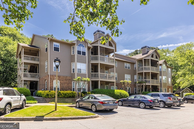 view of property with uncovered parking