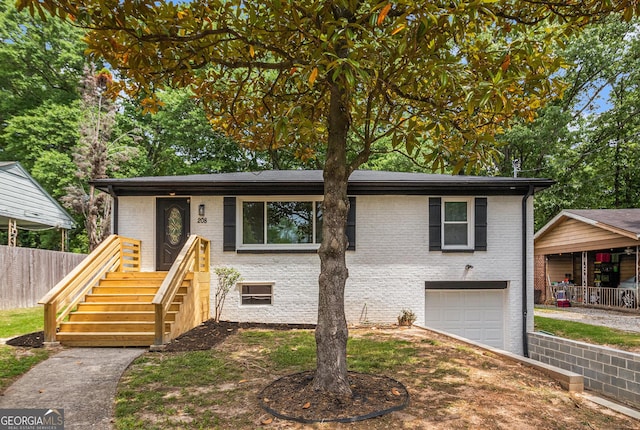 208 Silver Springs Cir SW, Atlanta, GA 30310 - view of front facade featuring a garage, fence, driveway, and brick siding