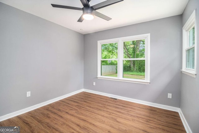 208 Silver Springs Cir SW, Atlanta, GA 30310 - spare room featuring baseboards, ceiling fan, wood finished floors, and a wealth of natural light