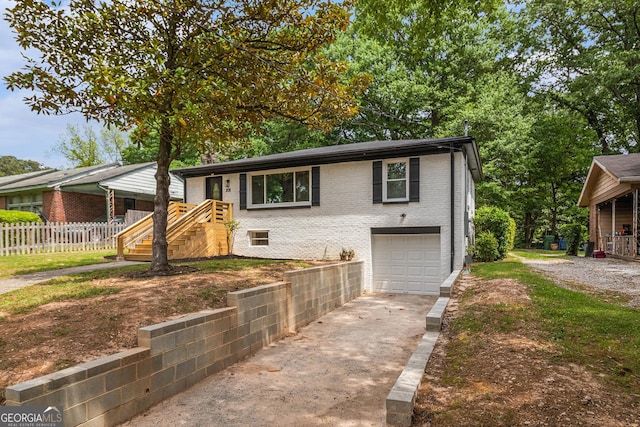 208 Silver Springs Cir SW, Atlanta, GA 30310 - view of front of home with a garage, fence, concrete driveway, and brick siding