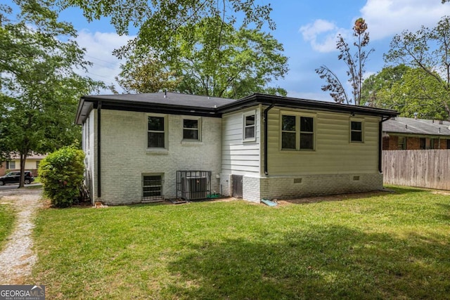 208 Silver Springs Cir SW, Atlanta, GA 30310 - rear view of house featuring a lawn, fence, brick siding, and cooling unit