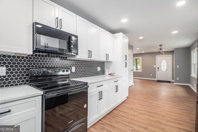 208 Silver Springs Cir SW, Atlanta, GA 30310 - kitchen with backsplash, light wood-type flooring, white cabinets, black appliances, and recessed lighting