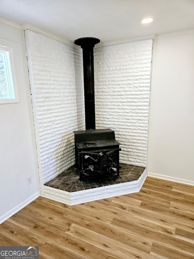 802 Colquitt Cir, Albany, GA 31707 - interior details with baseboards, a wood stove, wood finished floors, and ornamental molding