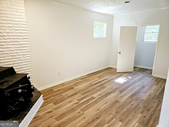 802 Colquitt Cir, Albany, GA 31707 - interior space with wood finished floors, ornamental molding, a wood stove, and multiple windows