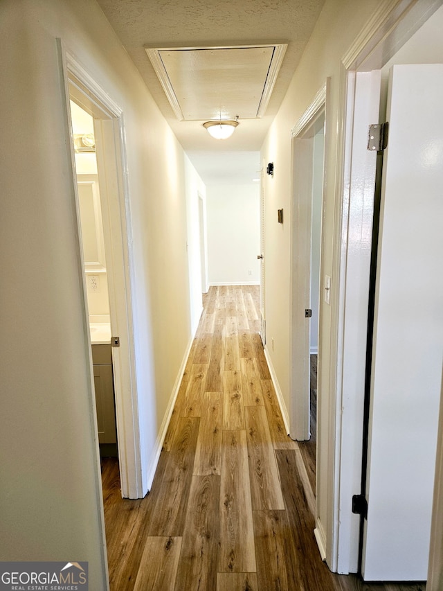 802 Colquitt Cir, Albany, GA 31707 - corridor featuring attic access, wood finished floors, and baseboards