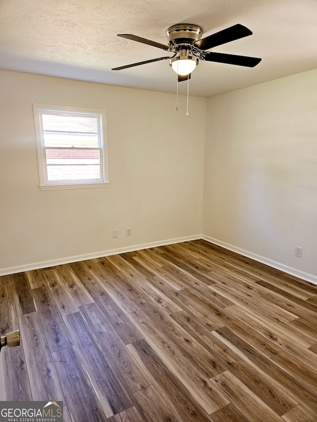 802 Colquitt Cir, Albany, GA 31707 - empty room featuring a ceiling fan, a textured ceiling, wood finished floors, and baseboards