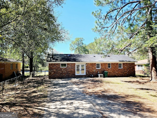 802 Colquitt Cir, Albany, GA 31707 - rear view of house featuring brick siding, driveway, french doors, and fence