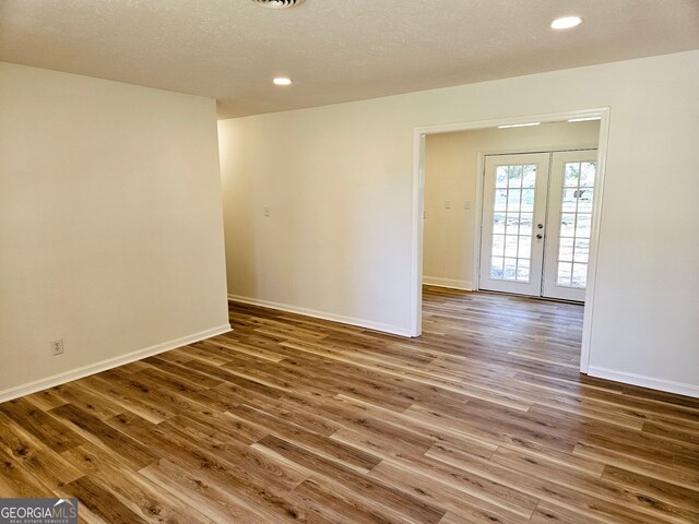 802 Colquitt Cir, Albany, GA 31707 - empty room with wood finished floors, french doors, recessed lighting, and baseboards