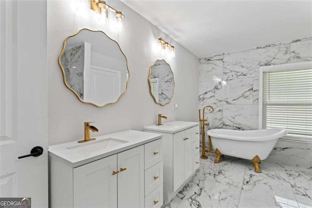 2023 Stoneleigh Dr, Stone Mountain, GA 30087 - bathroom with a freestanding tub, two vanities, marble finish floor, and a sink