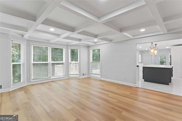 2023 Stoneleigh Dr, Stone Mountain, GA 30087 - unfurnished living room featuring a chandelier, light wood-style flooring, and baseboards