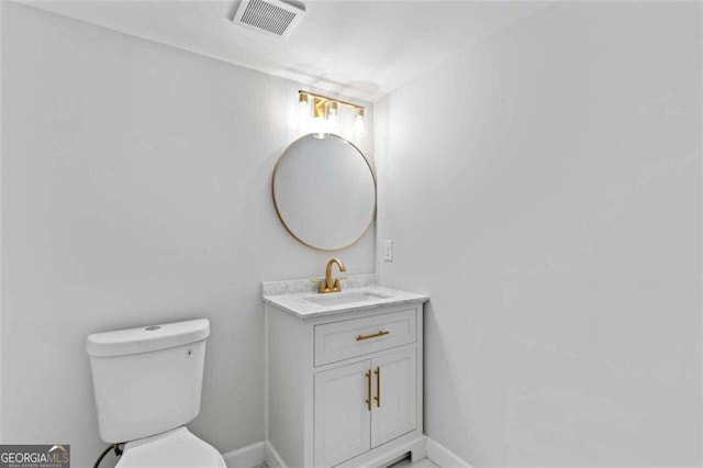 2023 Stoneleigh Dr, Stone Mountain, GA 30087 - half bath featuring toilet, visible vents, vanity, and baseboards