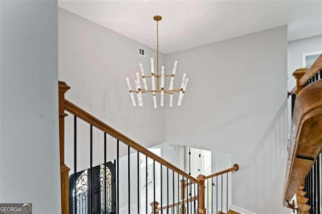 2023 Stoneleigh Dr, Stone Mountain, GA 30087 - stairway with baseboards, visible vents, a notable chandelier, and a high ceiling