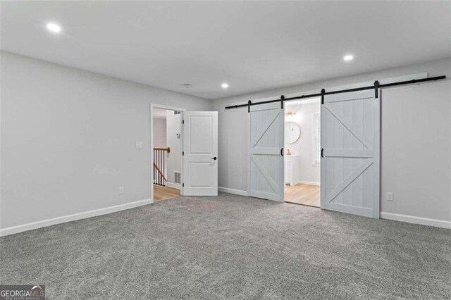 2023 Stoneleigh Dr, Stone Mountain, GA 30087 - unfurnished bedroom featuring baseboards, a barn door, carpet floors, and recessed lighting
