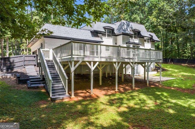 2023 Stoneleigh Dr, Stone Mountain, GA 30087 - back of property with a lawn, a wooden deck, stairs, and roof with shingles