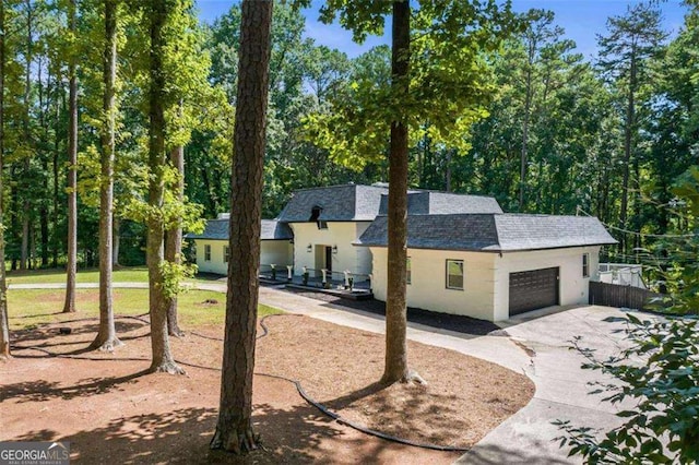 2023 Stoneleigh Dr, Stone Mountain, GA 30087 - view of front of house with a shingled roof, concrete driveway, and an attached garage