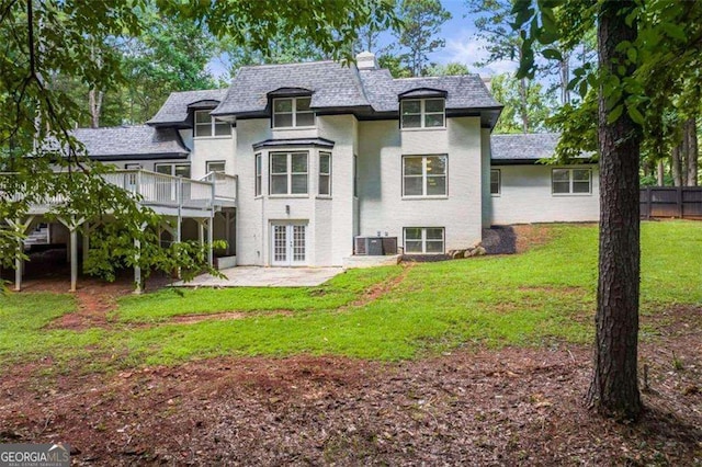 2023 Stoneleigh Dr, Stone Mountain, GA 30087 - rear view of house with a deck, fence, a patio area, french doors, and a lawn