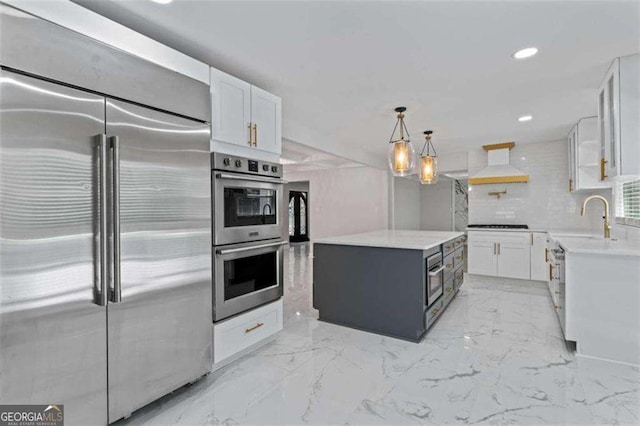 2023 Stoneleigh Dr, Stone Mountain, GA 30087 - kitchen with a sink, stainless steel appliances, custom range hood, a center island, and white cabinetry