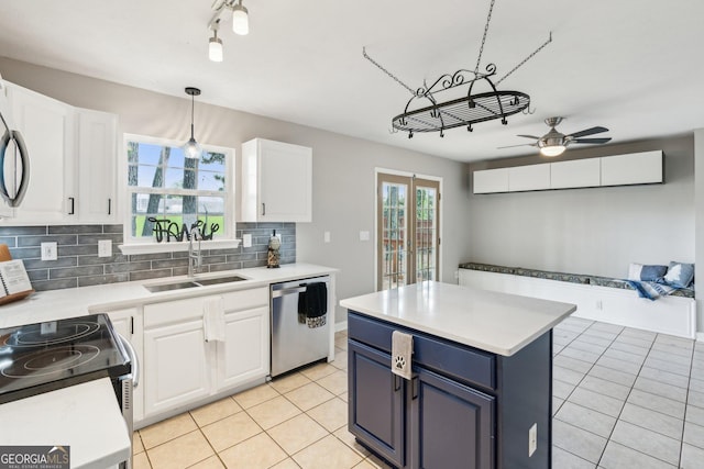 3979 Doral Cir, Atlanta, GA 30360 - kitchen with dishwasher, a sink, backsplash, light tile patterned floors, and white cabinets