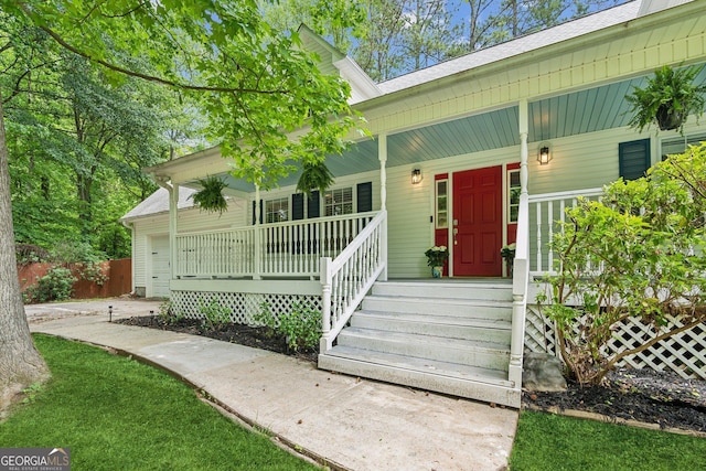 3979 Doral Cir, Atlanta, GA 30360 - view of exterior entry with covered porch, a garage, and a shingled roof