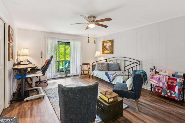bedroom featuring wood finished floors, a ceiling fan, and access to exterior