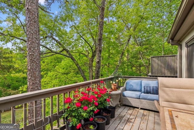 wooden terrace with outdoor lounge area