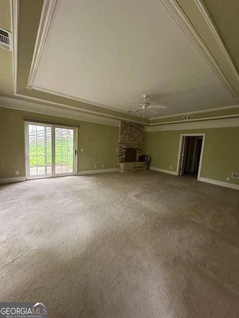 8010 Scudder Way, Ball Ground, GA 30107 - unfurnished living room with ornamental molding, ceiling fan, a fireplace, and carpet flooring
