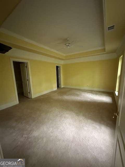 8010 Scudder Way, Ball Ground, GA 30107 - unfurnished room featuring carpet flooring, a raised ceiling, a ceiling fan, visible vents, and ornamental molding