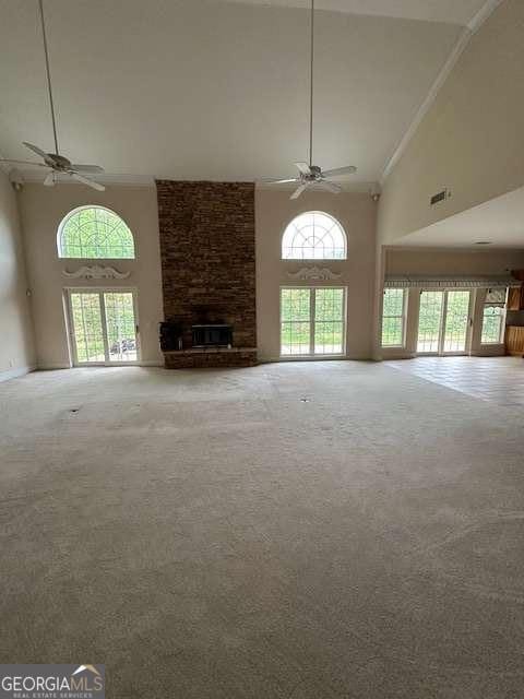 8010 Scudder Way, Ball Ground, GA 30107 - unfurnished living room with carpet flooring, a brick fireplace, high vaulted ceiling, ceiling fan, and visible vents