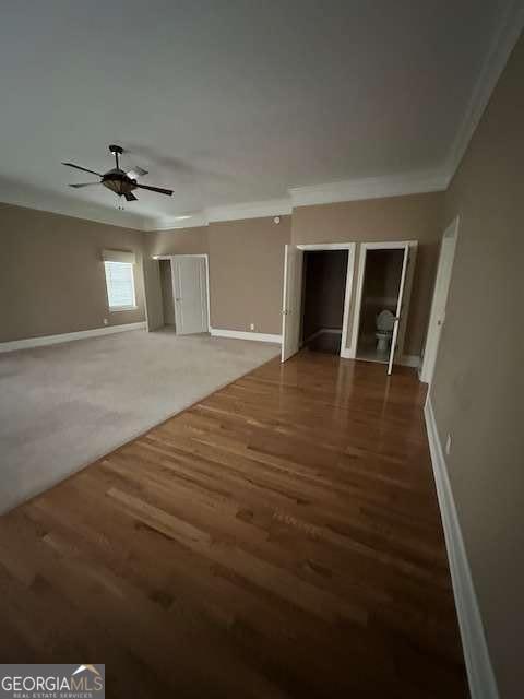 8010 Scudder Way, Ball Ground, GA 30107 - unfurnished living room with baseboards, ornamental molding, a ceiling fan, and wood finished floors